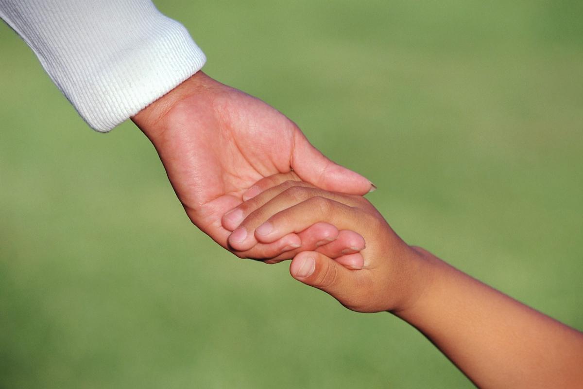 adult and child holding hands